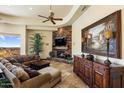 Comfortable living area featuring a stone fireplace, large painting and neutral tones at 10537 N Crestview Dr, Fountain Hills, AZ 85268