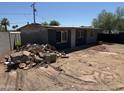 Wide shot of exterior of a grey house with dirt and gravel landscaping and some mountain views at 1535 E Christy Dr, Phoenix, AZ 85020