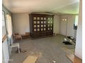 View of a living room with tile floors and an ornate hutch with decorations inside at 1535 E Christy Dr, Phoenix, AZ 85020