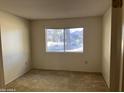 Cozy carpeted bedroom featuring a large window at 13410 W Bolero Dr, Sun City West, AZ 85375