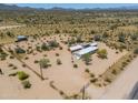Aerial view of a desert property with a house and outbuildings at 192 S Ralston Rd, Maricopa, AZ 85139