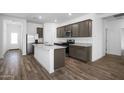 Modern kitchen boasts stainless steel appliances, granite countertops and wood flooring at 24567 W Alta Vista Rd, Buckeye, AZ 85326