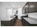 Modern kitchen with granite counters, stainless appliances, wood flooring, and ample cabinet space at 24567 W Alta Vista Rd, Buckeye, AZ 85326