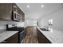 Bright kitchen features granite counters, a gas range, stainless appliances, and an open layout at 24567 W Alta Vista Rd, Buckeye, AZ 85326