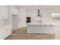 Bright kitchen featuring white cabinets, stainless steel appliances, and a center island at 4735 W Stargazer Pl, Laveen, AZ 85339