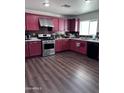 Kitchen with stainless steel appliances and red cabinets at 6245 W Southgate St, Phoenix, AZ 85043