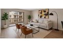 Cozy living room showcasing neutral decor, a balcony, and plenty of natural light at 7930 E Camelback Rd # 506, Scottsdale, AZ 85251