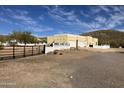 Charming single-story home featuring a neutral stucco exterior, a three-car garage and a secure fence at 44421 N 20Th St, New River, AZ 85087