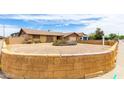 Single-story home featuring desert landscaping and a decorative brick retaining wall at 5625 N 47Th Ave, Glendale, AZ 85301