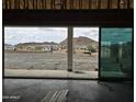 Spacious room with sliding glass doors opening up to a beautiful view of the desert landscape at 1973 W Brooke Ln, Queen Creek, AZ 85144