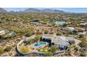 Expansive aerial view of luxury home with pool, putting green, and desert landscape with mountain views at 25583 N 89Th St, Scottsdale, AZ 85255