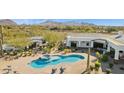 Stunning aerial view of a backyard pool with a spa and lounge chairs on a paved patio at 25583 N 89Th St, Scottsdale, AZ 85255