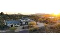 An aerial view of the neighborhood with a desert landscape, mountain views, and desert trees at 6737 E Rockaway Hills Dr, Cave Creek, AZ 85331