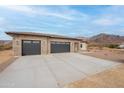 Lovely single-story home with a large driveway and a two car garage on a large desert lot at 9626 E Bunny Ear Ln, Gold Canyon, AZ 85118