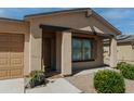 House entrance with brown door, window shutters, and walkway at 160 S Azteca Dr, Eloy, AZ 85131