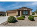 One-story house with tan exterior, landscaped yard, and two-car garage at 160 S Azteca Dr, Eloy, AZ 85131