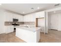 Modern kitchen with island and stainless steel appliances at 40500 W Wade Dr, Maricopa, AZ 85138