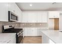 Modern kitchen featuring white cabinets and quartz countertops at 40500 W Wade Dr, Maricopa, AZ 85138