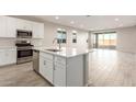 Open concept kitchen with island, stainless steel appliances, and tile flooring at 21641 N Daniel Dr, Maricopa, AZ 85138