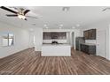 Open kitchen with a center island, dark wood cabinetry, and stainless steel appliances at 680 W Crowned Dove Trl, Casa Grande, AZ 85122