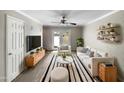 Cozy living room with neutral colors, ceiling fan, light wood accents, and access to outdoor space at 4925 N 73Rd St # 4, Scottsdale, AZ 85251