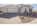 White two-car garage and front yard landscaping at 20277 W Mulberry Dr, Buckeye, AZ 85396