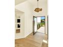 Inviting foyer featuring bright white walls, light wood floors, and unique decor at 4350 N Jokake Dr, Scottsdale, AZ 85251