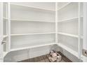 Walk-in pantry with white shelving and tile flooring at 20254 W Hollyhock St, Buckeye, AZ 85396