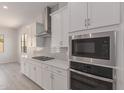 White kitchen features stainless steel appliances and gas cooktop at 16372 W Avenida Del Sol --, Surprise, AZ 85387