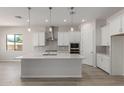 Modern kitchen with white cabinets, quartz countertops, and stainless steel appliances at 16372 W Avenida Del Sol --, Surprise, AZ 85387