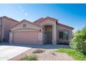 Charming home featuring a two-car garage, desert landscaping, and a secure screen door for added security at 10649 W Monte Vista Rd, Avondale, AZ 85392