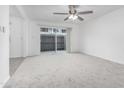 Living room with neutral carpet, brick wall, ceiling fan and fenced patio visible at 2610 W Berridge Ln # C115, Phoenix, AZ 85017