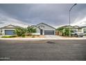 Well-kept single-story home featuring a two-car garage, clean landscaping, and a spacious driveway at 1157 W Paradise Way, Casa Grande, AZ 85122