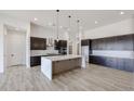 Spacious kitchen featuring a large island, dark cabinetry, and stainless steel appliances at 1101 E Dolores Rd, Phoenix, AZ 85086
