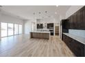 Bright, open-concept kitchen with modern cabinetry, a large island, and access to the living area at 1101 E Dolores Rd, Phoenix, AZ 85086