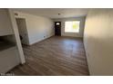 Bright living room featuring wood-look floors and a view to the front yard at 1091 N 84Th Pl, Scottsdale, AZ 85257