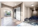 Condo hallway with elevator access and courtyard view at 11640 N Tatum Blvd # 2012, Phoenix, AZ 85028