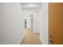 Hallway with wood floors and white walls and a glimpse of a living space at 7127 E Rancho Vista Dr # 4012, Scottsdale, AZ 85251