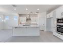 Bright kitchen featuring stainless steel appliances, a large island, and sleek white cabinets at 17632 W Oregon Ave, Litchfield Park, AZ 85340