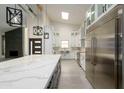 Bright kitchen with white cabinets, quartz countertops, and stainless steel appliances at 7917 E Bonnie Rose Ave, Scottsdale, AZ 85250