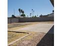 Large backyard showcasing a concrete patio area and block wall, offering a blank canvas for personalization at 3222 W Wagoner Rd, Phoenix, AZ 85053