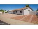 Exterior view of the house with driveway and low maintenance desert landscaping, perfect for easy care at 3222 W Wagoner Rd, Phoenix, AZ 85053