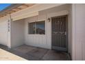 Front door with security screen, adjacent window, and house numbers, providing curb appeal and security at 3222 W Wagoner Rd, Phoenix, AZ 85053