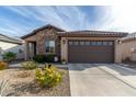 Single-story home with stone accents and a two-car garage at 26935 W Zachary Dr, Buckeye, AZ 85396