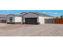 New home exterior with a two-car garage and rock driveway at 4160 N Kioha Dr, Eloy, AZ 85131