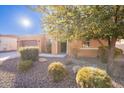 Front view of a single-story house with a tree and shrubs at 1681 E Grand Ridge Rd, Queen Creek, AZ 85140