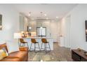 Open kitchen with island seating provides a seamless flow to the living area at 2511 W Queen Creek Rd # 179, Chandler, AZ 85248