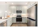 Modern kitchen boasts stainless steel appliances, ample cabinet space, and sleek countertops at 2511 W Queen Creek Rd # 179, Chandler, AZ 85248