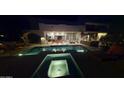 Stunning backyard with a sparkling pool, spa, and outdoor fire pit for elegant evening entertaining at 9233 S Krista E Dr, Goodyear, AZ 85338