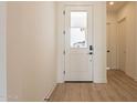 Bright entryway with white door and wood-look flooring at 17990 W Long Lake Rd, Goodyear, AZ 85338